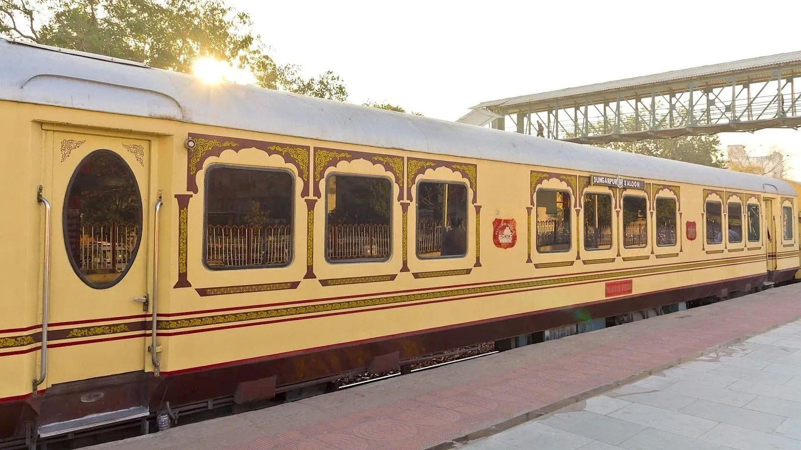 Ornate carriage of a heritage luxury train at golden hour